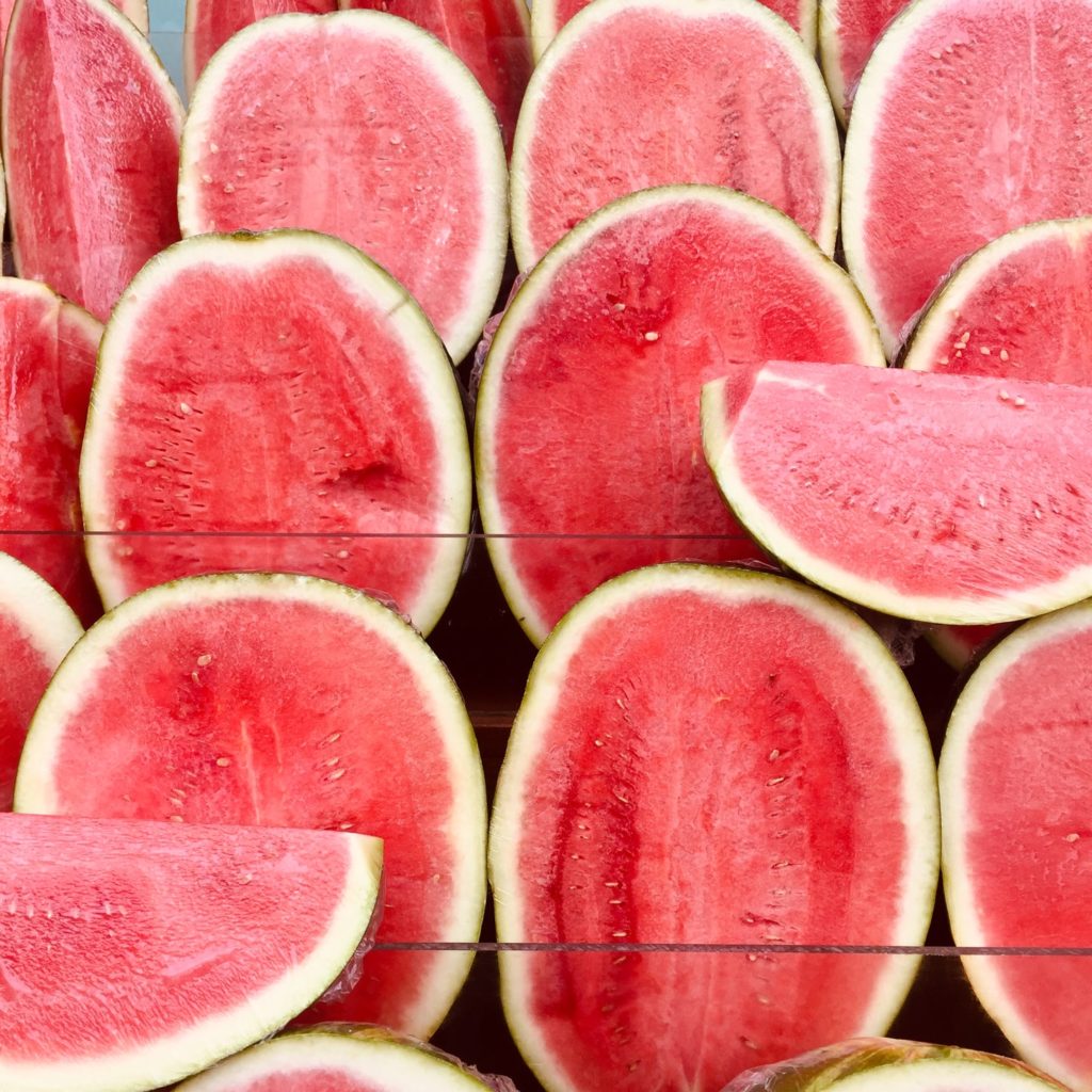 alt text: image is a color photograph of sliced watermelons; title card for the craft essay "Gurov's Watermelon" by Patrick Thomas Henry