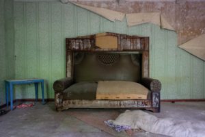 alt text: image is a color photograph of a weathered couch; title card for Beth Kephart's creative nonfiction piece "Thieves"