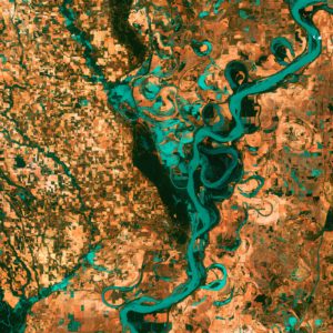 alt text: image is a color graphic of a zoomed-out terrain; title card for Madari Pendas's flash fiction piece "Instructor Feedback"