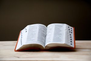 alt text: image is a color photograph of an open dictionary; title card for CRAFT's new column, "The Glossary: A Concise, Evolving Guide to the Elements of Literary Craft"